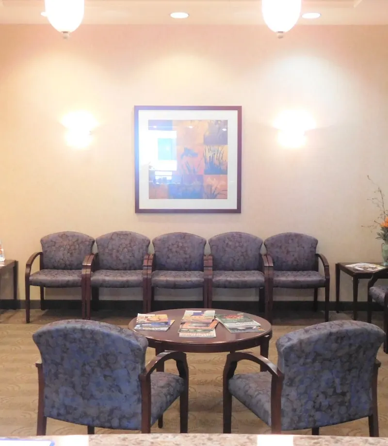 The waiting room, with upholstered chairs around a table of magazines.